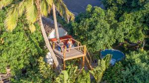 an aerial view of a resort with a palm tree at Kitesurf Tofo House - 1 minute walk from beach and center in Praia do Tofo