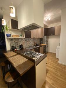 a kitchen with a stove and a counter top at Blue Zen beachfront apartment in Civitanova Marche +7 photos