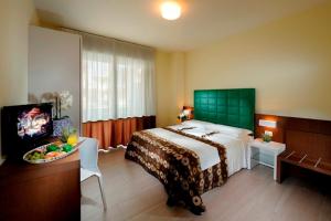 Postel nebo postele na pokoji v ubytování Hotel Luciana