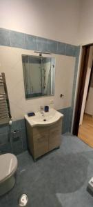 a bathroom with a sink and a toilet and a mirror at Il Palazzetto in Velletri
