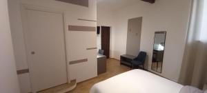 a bedroom with a bed and a desk and a mirror at Il Palazzetto in Velletri