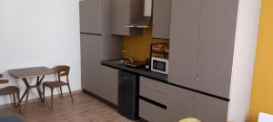 a kitchen with a counter with a microwave and a table at Il Palazzetto in Velletri