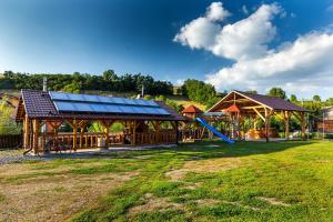 a playground with a pavilion and a slide at Erőss Kulcsosház in Lăzarea