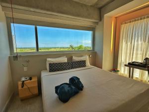 a bedroom with a large bed with a large window at Ribalta Hotel Barra da Tijuca by Atlantica in Rio de Janeiro +54 photos