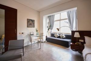 a bedroom with a couch and a table and a bed at Urban Opulence in Bangalore +139 photos
