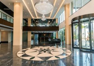 a large lobby with a large chandelier in a building at Kinno International Hotel in Tema +48 photos