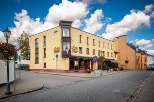 a building on a street in a town at Hotel-Restaurant Smilga in Kėdainiai