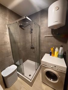 a shower in a bathroom with a washing machine at Mima in Sarajevo
