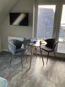 a dining room with a table and two chairs at Skyefall Apartment in Uig