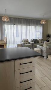 a kitchen with a counter top and a living room at Villa on Private Estate with Pool in Hermanus +82 photos
