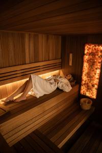 a person is laying in a sauna at Hotel Borowiecki in Łódź