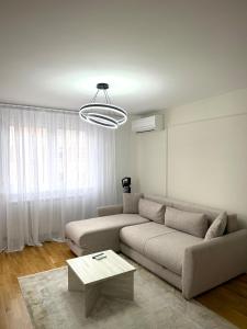 a living room with a couch and a table at Apartman 307 in Lukavica