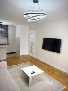 a living room with a couch and a coffee table at Apartman 307 in Lukavica
