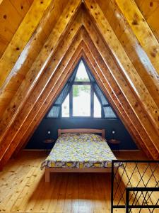a bedroom with a bed in a attic at Ataraksija in Mijakovići