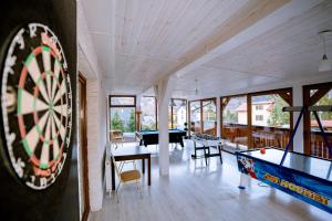a room with a dart board and a ping pong table at Aldian Pokoje Gościnne in Szczyrk