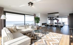 a living room with a couch and a table at Maris Apartments in Egmond aan Zee