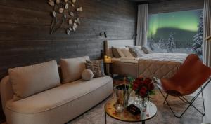 a living room with a couch and a bed and a table at Arctic Panorama Resort in Rovaniemi