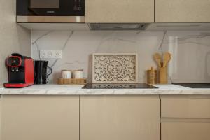 a kitchen with a counter top with a red appliance at 304 Chanzy - T1 Spacieux - Gare & Centre - Wifi in Le Mans