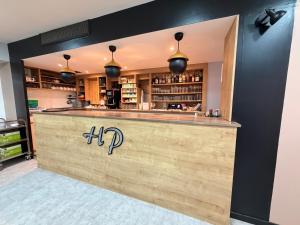 a bar in a restaurant with a counter at Logis Hôtel de Paris - Restaurant - Pâtisserie in Saint-Avold