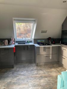 a kitchen with a sink and a window at Skyefall Apartment in Uig