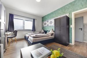 a living room with a bed and a couch at Heide Ferienwohnung Süd Nr-2 in Schneverdingen