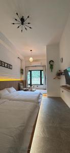 a bedroom with two beds and a ceiling fan at 陌野輕旅民宿 in Xiulin