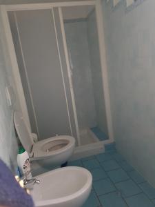 a bathroom with a toilet and a shower at Appartamento Cervia in Cervia