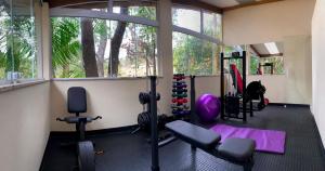 a gym with exercise equipment and a large window at Della Vegas Economy in Serra Negra