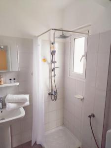 a bathroom with a shower and a sink at Homeric Poems in Argostoli +17 photos