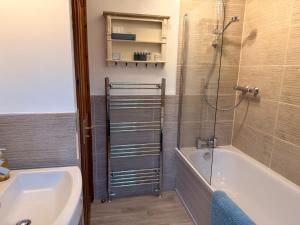 a bathroom with a shower and a tub and a sink at Campden Place - 2 Bed Home in Central Chipping Campden in Chipping Campden +16 photos
