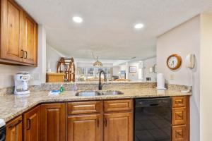 a kitchen with a sink and a dishwasher at Pier Point South Ocean View Condo B-22 in St. Augustine
