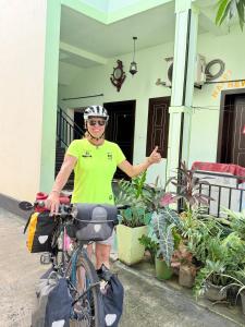 a man riding a bike in front of a house at SSF Green Home in Akkaraipattu +26 photos
