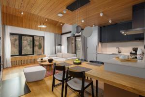 a kitchen and living room with a table and chairs at Mountain Retreat by Dukley in Kolašin