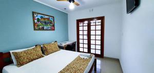 a bedroom with a white bed and a window at Della Vegas Economy in Serra Negra