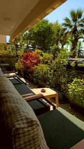 a patio with a table and chairs and plants at Elegant & Cozy Retreat Home, City Center Gem, At the Seaside, Steps from the Tram in Konak