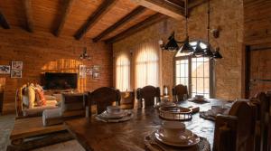 a dining room with a table and a living room at Golden Heights Resort in Al Ḩanī