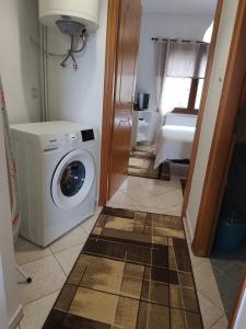 a laundry room with a washing machine in it at Mountain Serenity junior in Konitsa