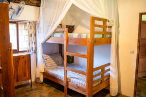 a bedroom with two bunk beds in a room at Kitesurf Tofo House - 1 minute walk from beach and center in Praia do Tofo +49 photos