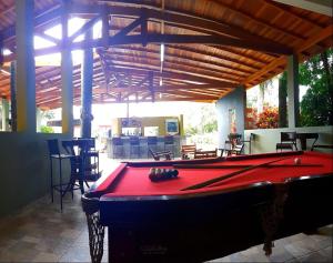 a pool table sitting inside of a building with awning at Della Vegas Economy in Serra Negra