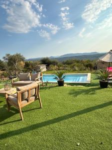 a yard with a bench and a swimming pool at Prestige villa Estrella in Fayence