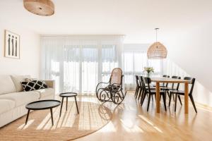 a living room with a couch and a table at Summit View Apartment in Spiez