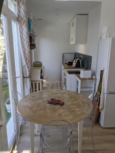 a kitchen with a table and chairs in a kitchen at Penuel Tiny House in Granville