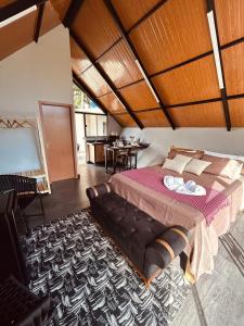 a bedroom with a large bed with a wooden ceiling at Kabana Harmony in Aquidauana