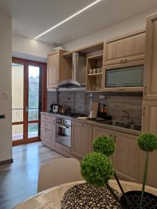 a kitchen with stainless steel appliances and wooden cabinets at Sogno tra le Torri in San Gimignano