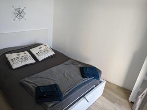 a bed in a room with two pillows on it at Penuel Tiny House in Granville
