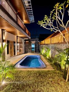 a swimming pool in the backyard of a house at Tanhana Seminyak in Kerobokan +28 photos