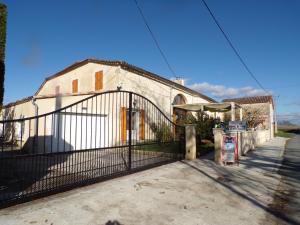 an old building with a gate in front of it at La Grange in Dieulivol