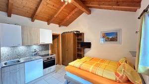 a small kitchen with a bed and a sink at Chalet Stadel in Saas-Grund +53 photos