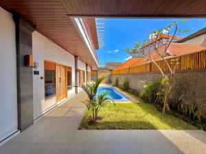 an external view of a house with a swimming pool at Tanhana Seminyak in Kerobokan