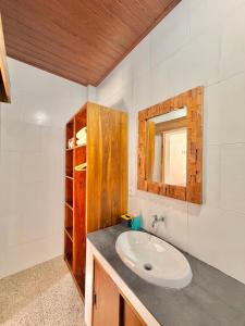 a bathroom with a sink and a mirror at Tanhana Seminyak in Kerobokan